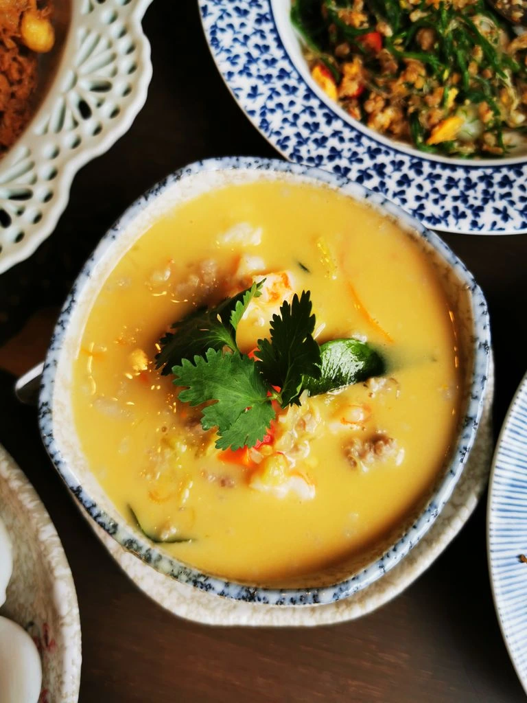Curry vegano de garbanzos, boniato y espinacas en cuenco oscuro con cilantro fresco.